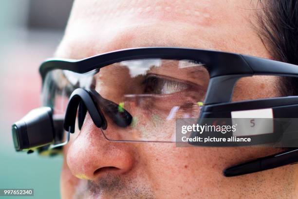 An emergency medic wears computer glasses during a disaster drill in Aachen, Germany, 30 July 2017. Scientists want to use the glasses in order to...