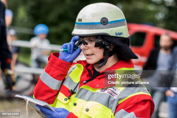 An emergency medic wears computer glasses during a disaster drill in Aachen, Germany, 30 July 2017. Scientists want to use the glasses in order to...