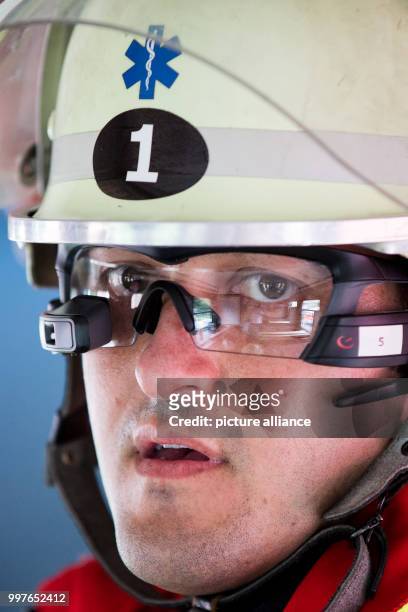 An emergency medic wears computer glasses during a disaster drill in Aachen, Germany, 30 July 2017. Scientists want to use the glasses in order to...