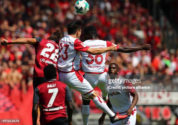 Nuremberg's Enrico Valentini and Edgar Salli and Kaiserslautern's Baris Atik and Manfred Osei Kwadwo in action during the German 2nd Bundesliga...