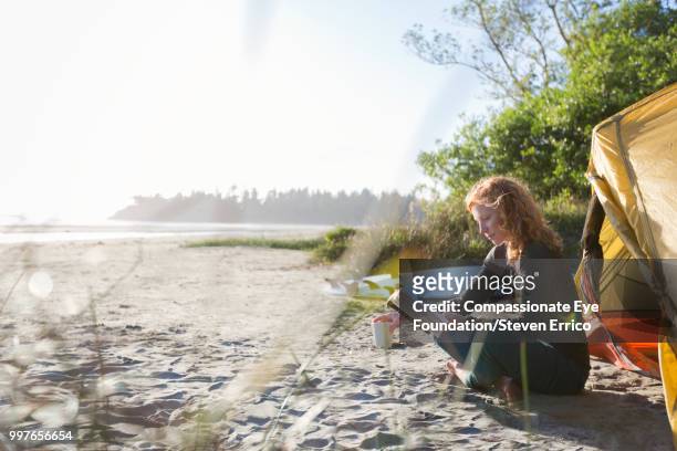 woman reading book on beach - cef do not delete stock pictures, royalty-free photos & images