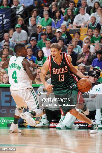 Luke Ridnour of the Milwaukee Bucks drives the ball against Nate Robinson of the Boston Celtics on April 14, 2010 at the TD Garden in Boston,...
