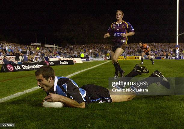 Paul Mellor of the Sharks scores a try as Darren Lockyer of the Broncos watches on during the NRL qualifying final between the Sharks and the...