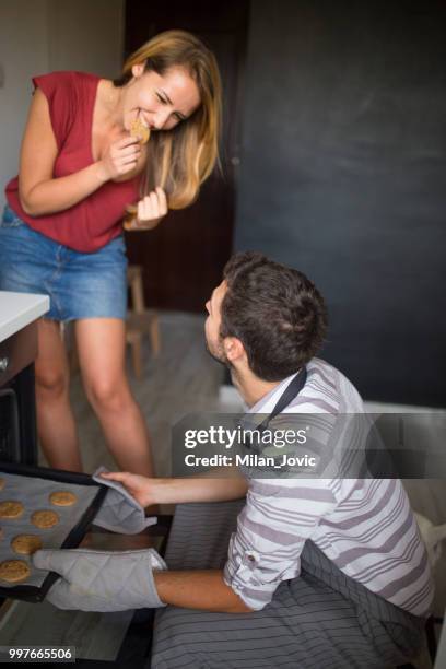 young man checking food in oven low angle view - jovic stock pictures, royalty-free photos & images