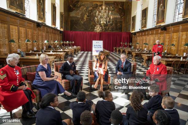 First Lady Melania Trump, center, and Philip May, husband of U.K. Prime Minister Theresa May, third right, meet with school children during a visit...