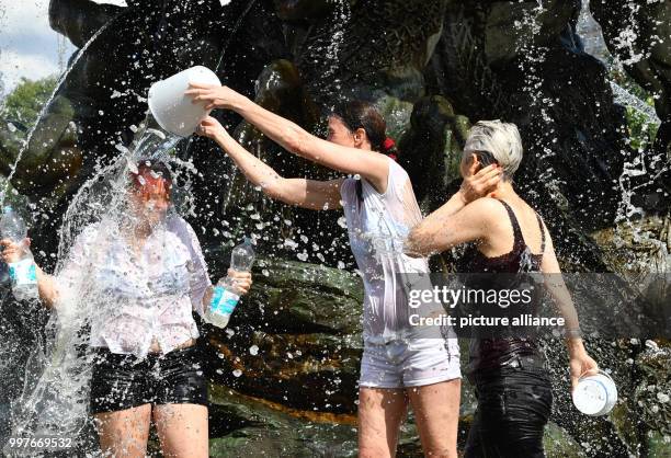 Participants of a water fight at and in the Neptune Fountain enjoy the hot weather in Berlin, Germany, 30 July 2017. The event was organised via...