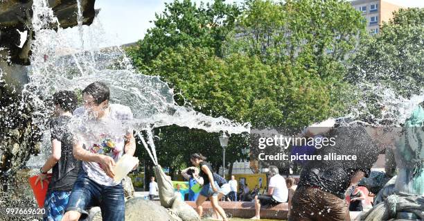 Participants of a water fight at and in the Neptune Fountain enjoy the hot weather in Berlin, Germany, 30 July 2017. The event was organised via...