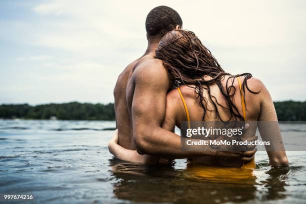 couple wading in the water at lake - atlanta georgia food stock pictures, royalty-free photos & images