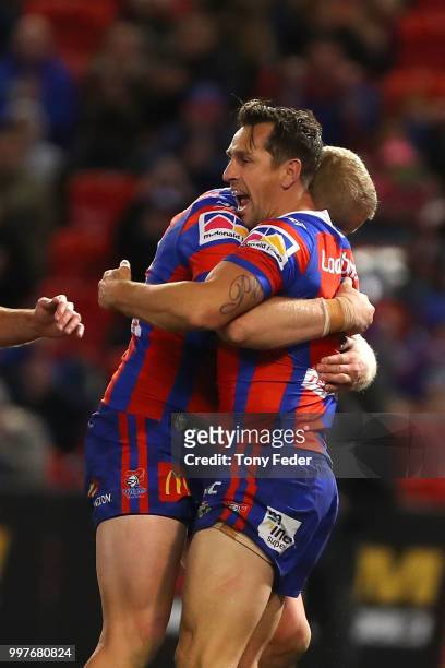 Mitchell Pearce of the Knights celebrates a try with a team mate during the round 18 NRL match between the Newcastle Knights and the Parramatta Eels...