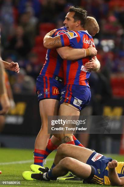 Mitchell Pearce of the Knights celebrates a try with a team mate during the round 18 NRL match between the Newcastle Knights and the Parramatta Eels...