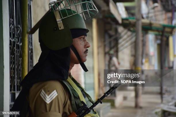 Indian paramilitary soldiers stand guard during curfew in Srinagar, Indian controlled Kashmir on Friday. July 13 is observed as Martyrs' Day in...