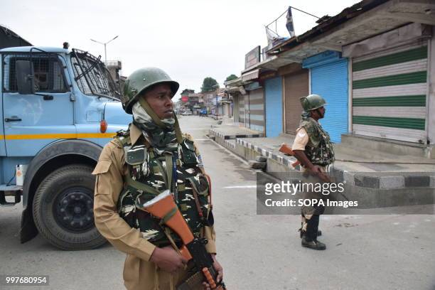 Indian paramilitary soldiers stand guard during curfew in Srinagar, Indian controlled Kashmir on Friday. July 13 is observed as Martyrs' Day in...