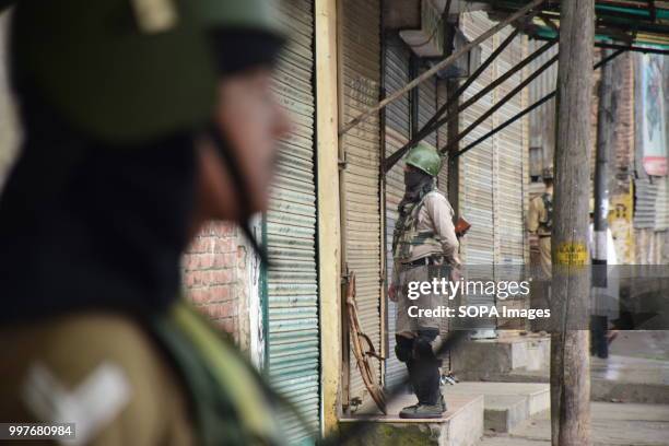 Indian paramilitary soldiers stand guard during curfew in Srinagar, Indian controlled Kashmir on Friday. July 13 is observed as Martyrs' Day in...