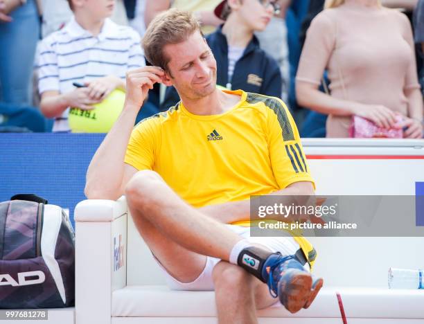 Florian Mayer of Germany sitting after his defeat to Leonardo Mayer of Argentina in the men's singles final of the Tennis ATP-Tour German Open in...