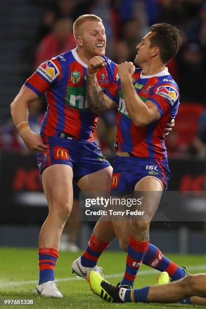 Mitchell Pearce and Mitch Barnett of the Knights celebrate a try during the round 18 NRL match between the Newcastle Knights and the Parramatta Eels...