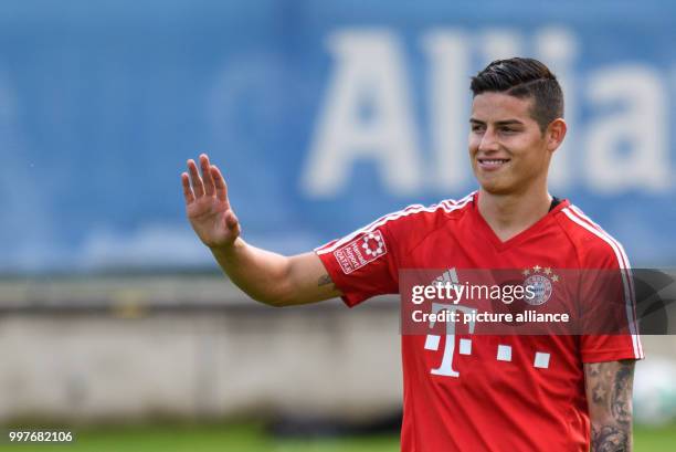 James Rodriguez of Bayern Munich greets the fans watching the training session at the club's training ground on Saebener Strasse in Munich, Germany,...