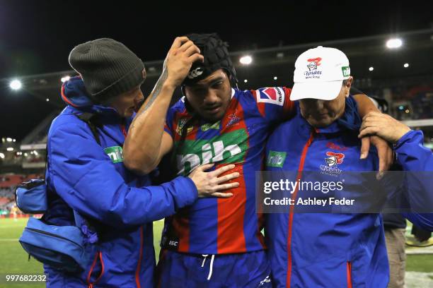 Sione Mata'Utia of the Knights is walked off for an injury during the round 18 NRL match between the Newcastle Knights and the Parramatta Eels at...