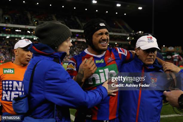Sione Mata'Utia of the Knights is walked off for an injury during the round 18 NRL match between the Newcastle Knights and the Parramatta Eels at...