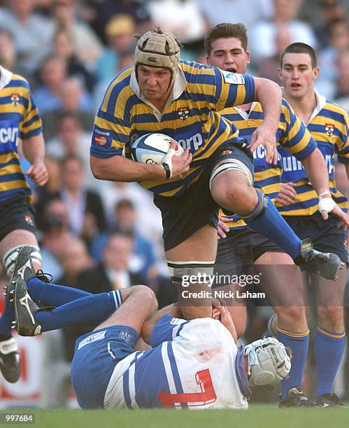 Dan Vickerman of University runs over Adam Leach of Eastwood during the Citibank Mastercard Cup grand final between Sydney University and Eastwood...