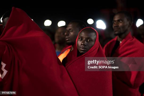 Sub saharan migrants covered with red blanket wait to be registered by Red Cross. 107 Sub saharan migrants were rescued in Alboran sea by Spanish...