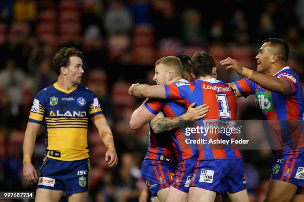 Mitchell Pearce of the Knights celebrates his try with Mitch Barnett during the round 18 NRL match between the Newcastle Knights and the Parramatta...