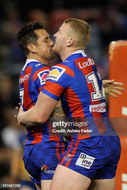 Mitchell Pearce of the Knights celebrates his try with Mitch Barnett during the round 18 NRL match between the Newcastle Knights and the Parramatta...