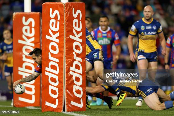 Mitchell Pearce of the Knights scores a try during the round 18 NRL match between the Newcastle Knights and the Parramatta Eels at McDonald Jones...