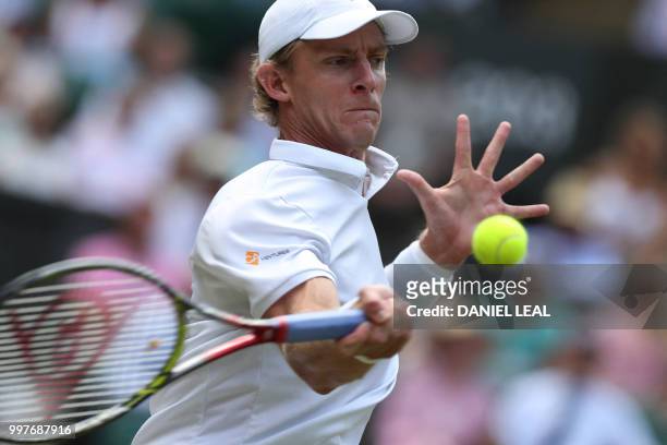 South Africa's Kevin Anderson returns against US player John Isner during their men's singles semi-final match on the eleventh day of the 2018...