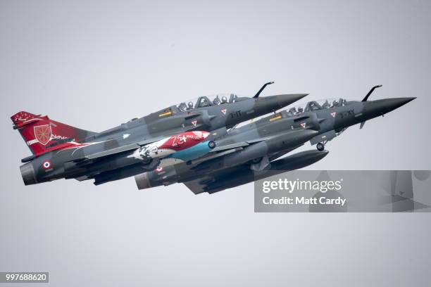 Two Couteau Delta Mirage 2000Ds perform at the Royal International Air Tattoo at RAF Fairford on July 13, 2018 in Fairford, Gloucestershire, England....