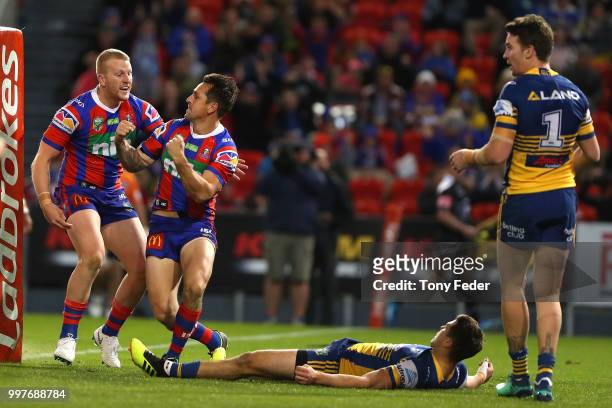 Mitchell Pearce and Mitch Barnett of the Knights celebrate a try during the round 18 NRL match between the Newcastle Knights and the Parramatta Eels...
