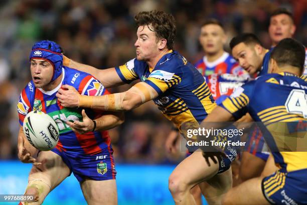 Jamie Buhrer of the Knights is tackled during the round 18 NRL match between the Newcastle Knights and the Parramatta Eels at McDonald Jones Stadium...