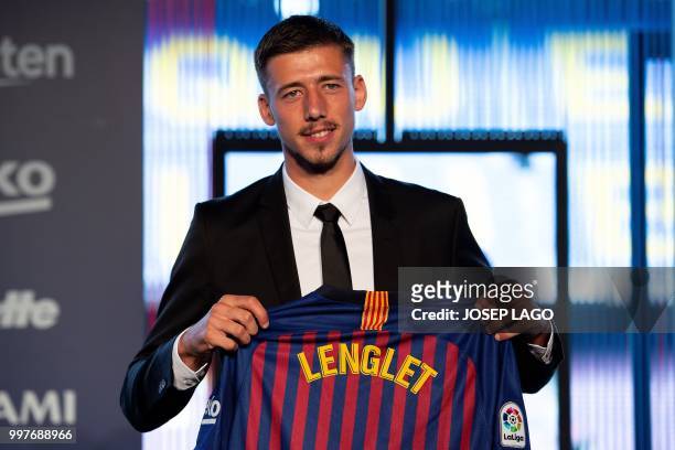Barcelona«'s new player French defender Clement Lenglet poses with his new jersey during his official presentation at the Camp Nou stadium in...