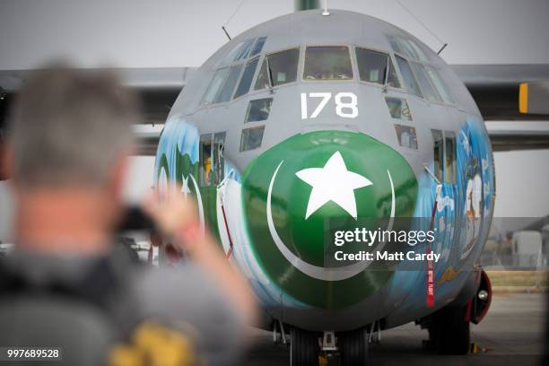 People take photographs of a Pakistan air Force C-130E Hercules at the Royal International Air Tattoo at RAF Fairford on July 13, 2018 in Fairford,...