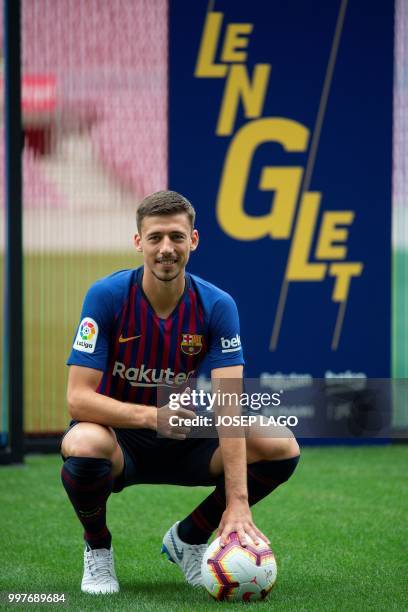 Barcelona's new player French defender Clement Lenglet poses during his official presentation at the Camp Nou stadium in Barcelona on July 13, 2018....