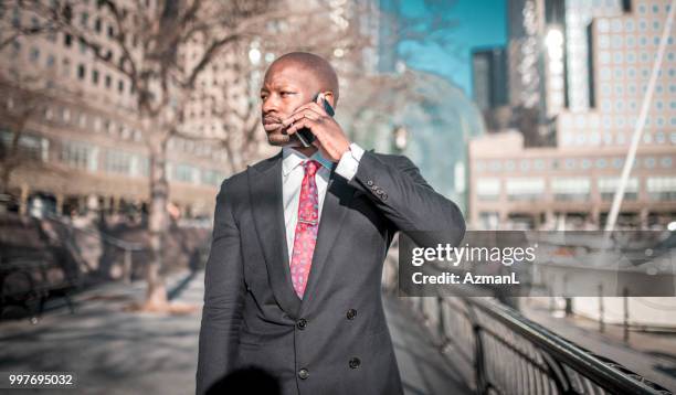 smiling businessman using phone on the go - 1626 stock pictures, royalty-free photos & images