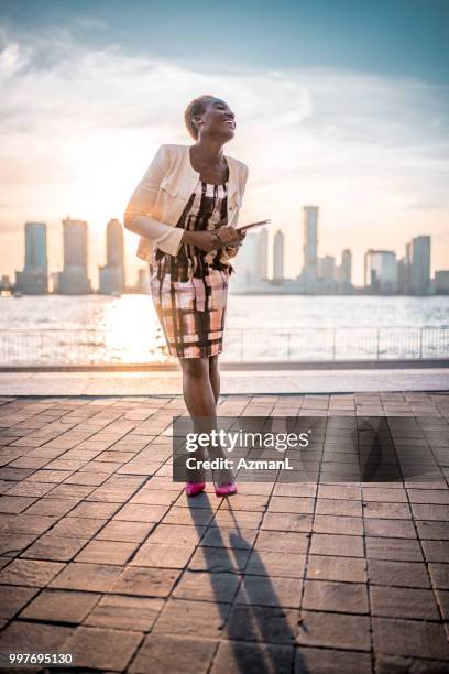 smiling businesswoman on the go - businesswoman nyc stock pictures, royalty-free photos & images