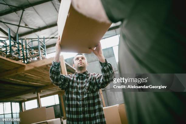 factory worker loading carton boxes for shipping - aleksandar georgiev stock pictures, royalty-free photos & images