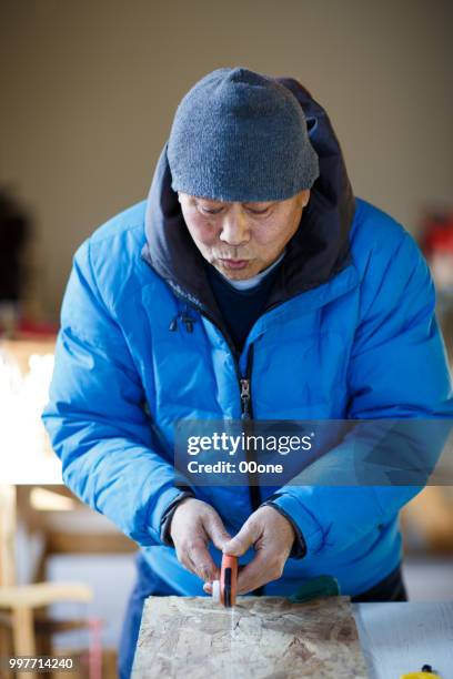 mature carpenter cutting wooden plank - serrated stock pictures, royalty-free photos & images