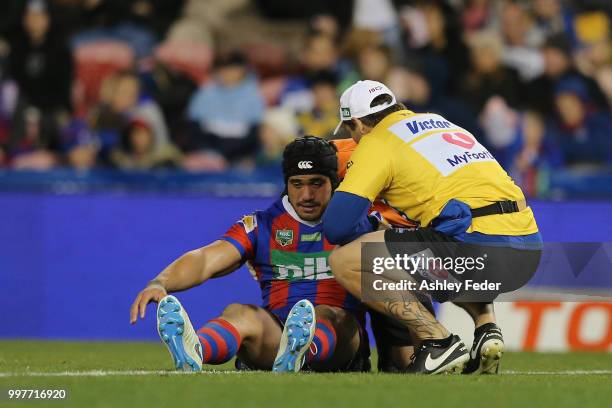 Sione Mata'Utia of the Knights is taken off for an injury yduring the round 18 NRL match between the Newcastle Knights and the Parramatta Eels at...