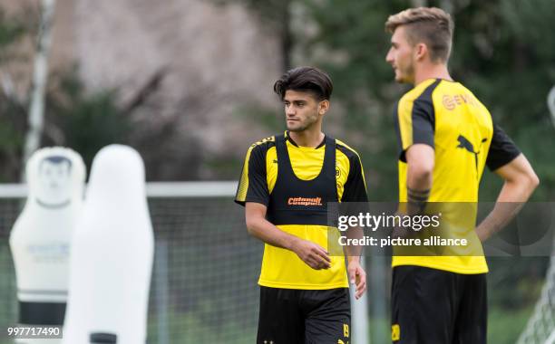 Dortmund's Mahmoud Dahoud and Maximilian Philipp stand on the pitch during the training camp of German soccer club Borussia Dortmund in Bad Ragaz,...