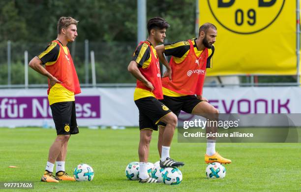 The three new Dortmund players Maximilian Philipp, Mahmoud Dahoud und Ömer Toprak stand together on the pitch during the training camp of German...