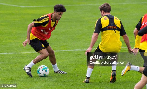 Dortmund's Mahmoud Dahoud and Mario Goetze vie for the ball during the training camp of German soccer club Borussia Dortmund in Bad Ragaz,...