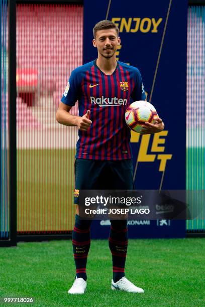 Barcelona's new player French defender Clement Lenglet poses during his official presentation at the Camp Nou stadium in Barcelona on July 13, 2018....