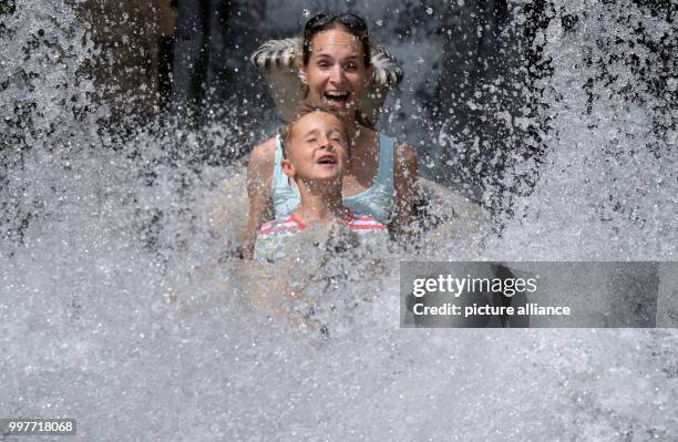 Anika Knoebel and little Paul take a fun ride in the adventure park Tripsdrill in Cleebronn, Germany, 31 July 2017. Photo: Marijan Murat/dpa