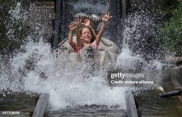 Maya and Jana take a fun ride in the adventure park Tripsdrill in Cleebronn, Germany, 31 July 2017. Photo: Marijan Murat/dpa