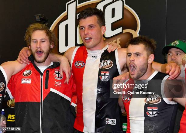 Jimmy Webster, Rowan Marshall and Maverick Weller of the Saints sing the song in the rooms after winning the round 17 AFL match between the St Kilda...