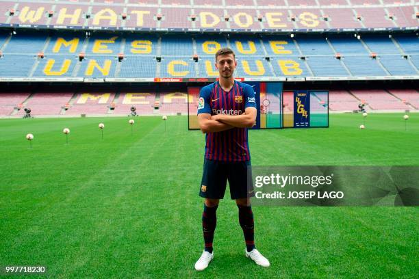 Barcelona's new player French defender Clement Lenglet poses during his official presentation at the Camp Nou stadium in Barcelona on July 13, 2018....