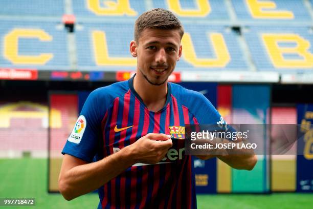 Barcelona«'s new player French defender Clement Lenglet poses with his new jersey during his official presentation at the Camp Nou stadium in...