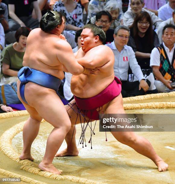 Sekiwake Mitakeumi pushes Shodai out of the ring to win on day six of the Grand Sumo Nagoya Tournament at the Dolphin's Arena on July 13, 2018 in...