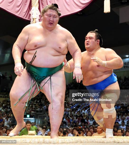 Kotoshogiku pushes Mongolian sekiwake Ichinojo out of the ring to win on day six of the Grand Sumo Nagoya Tournament at the Dolphin's Arena on July...